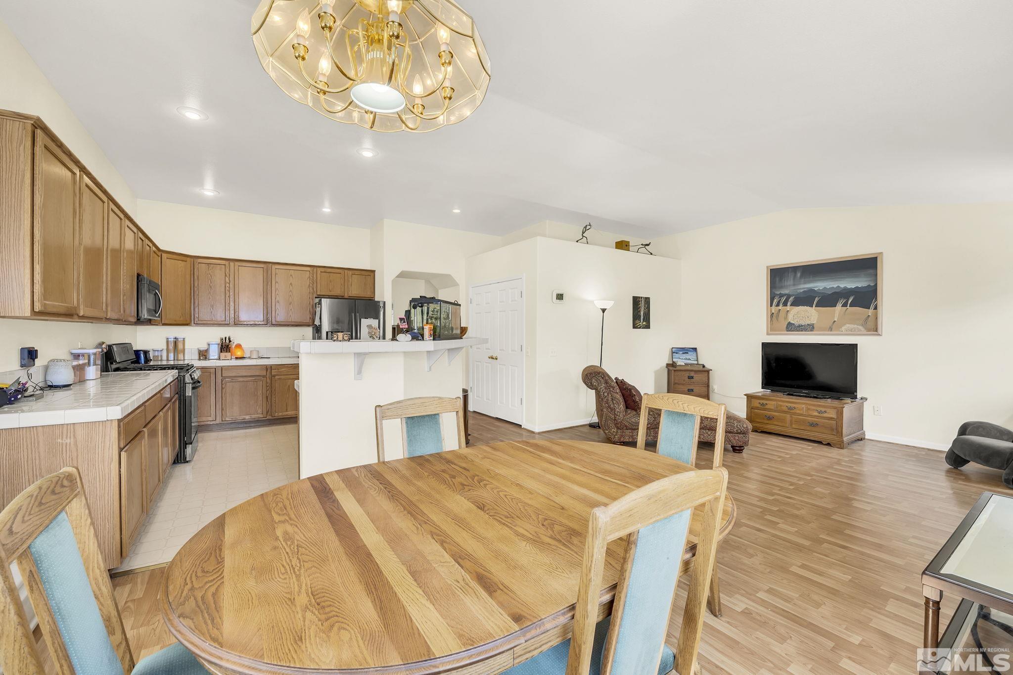 407 Sunshine Lane Fernley, NV 89408 - Photo 12 of 26 a large kitchen with a table and chairs