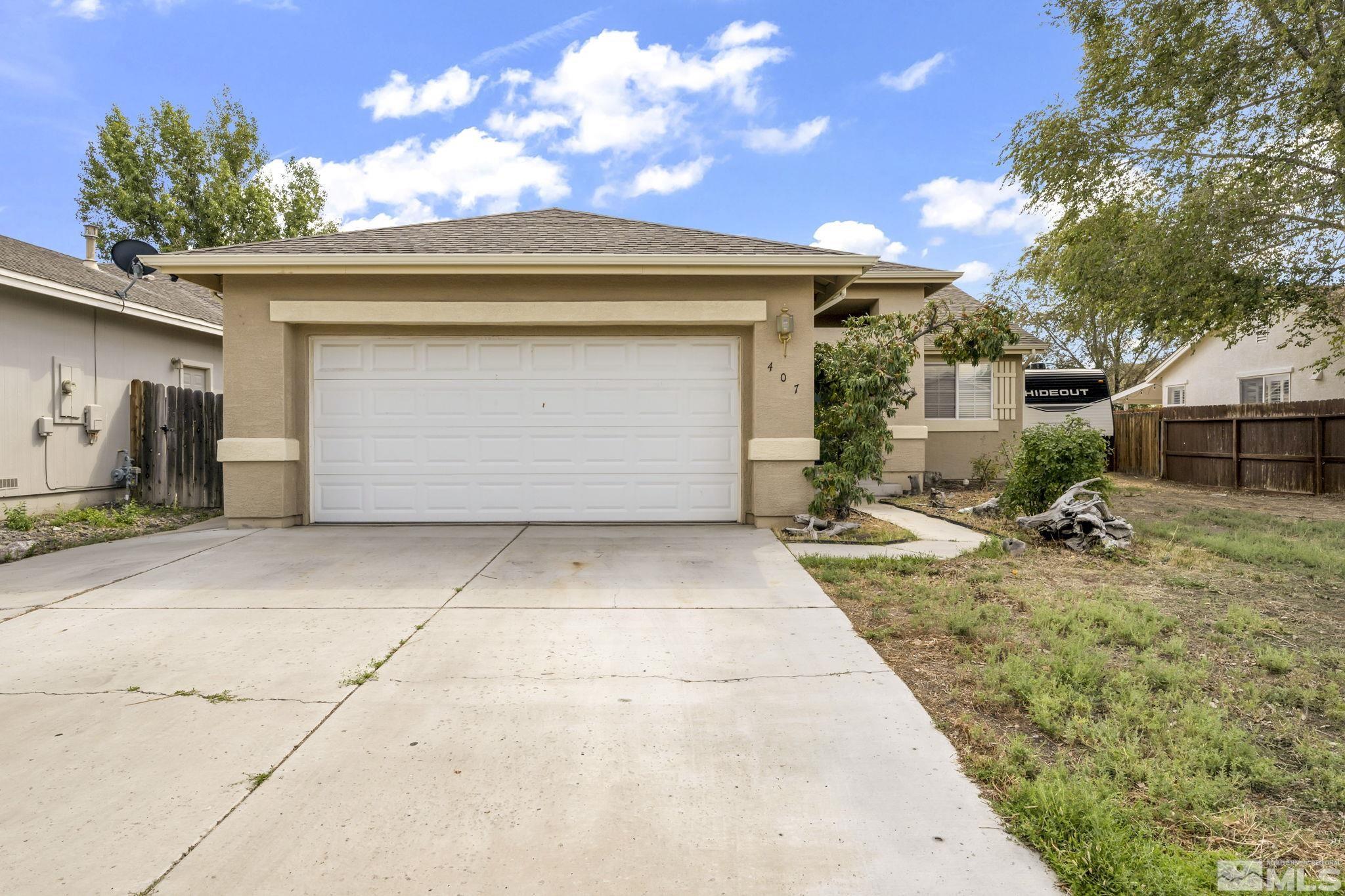 407 Sunshine Lane Fernley, NV 89408 - Photo 2 of 26 a view of garage yard and deck