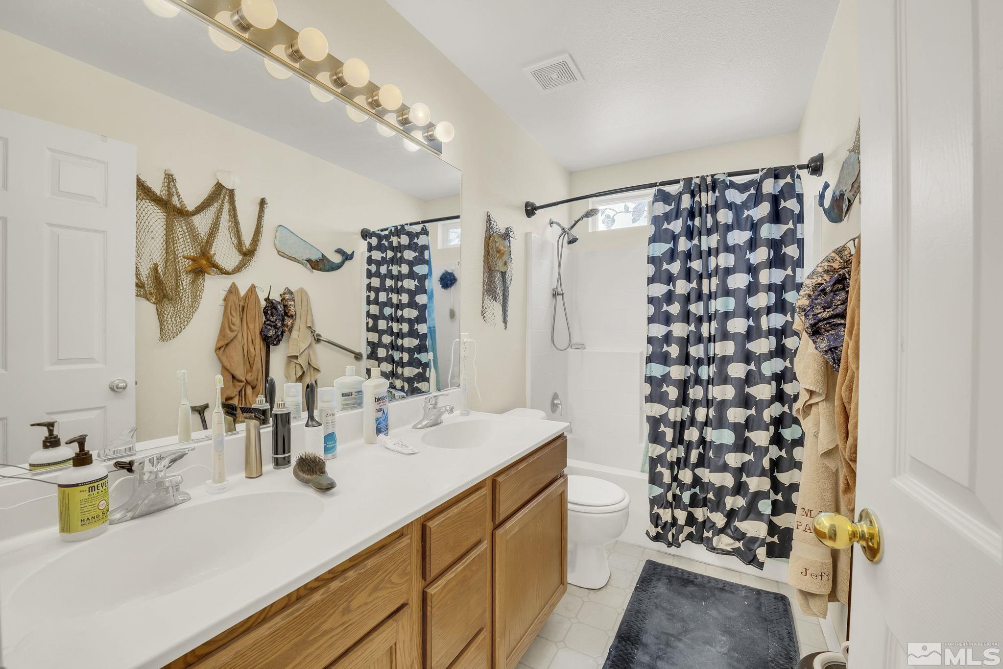 407 Sunshine Lane Fernley, NV 89408 - Photo 21 of 26 a bathroom with a double vanity sink mirror and shower
