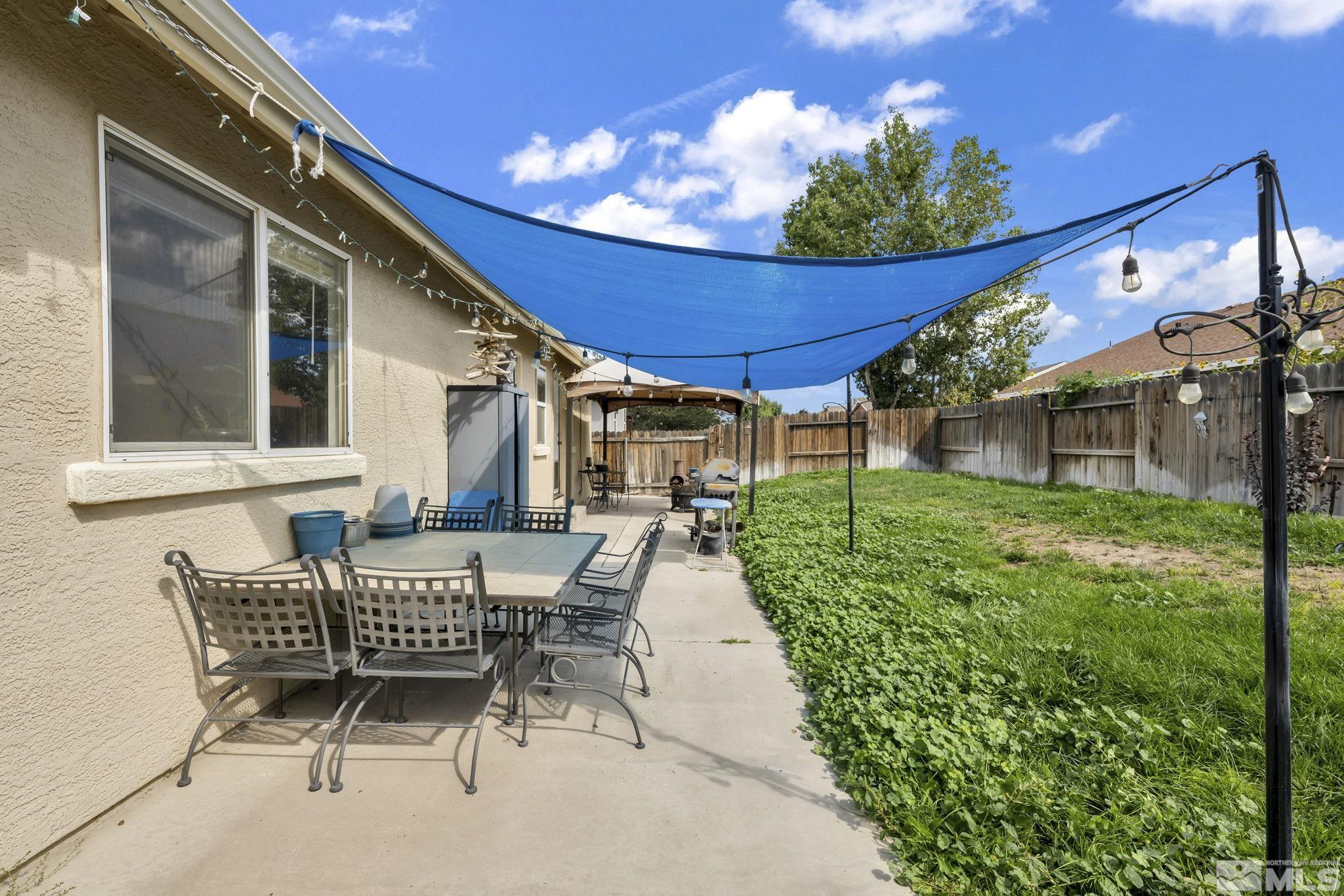 407 Sunshine Lane Fernley, NV 89408 - Photo 23 of 26 a view of a house with backyard and sitting area