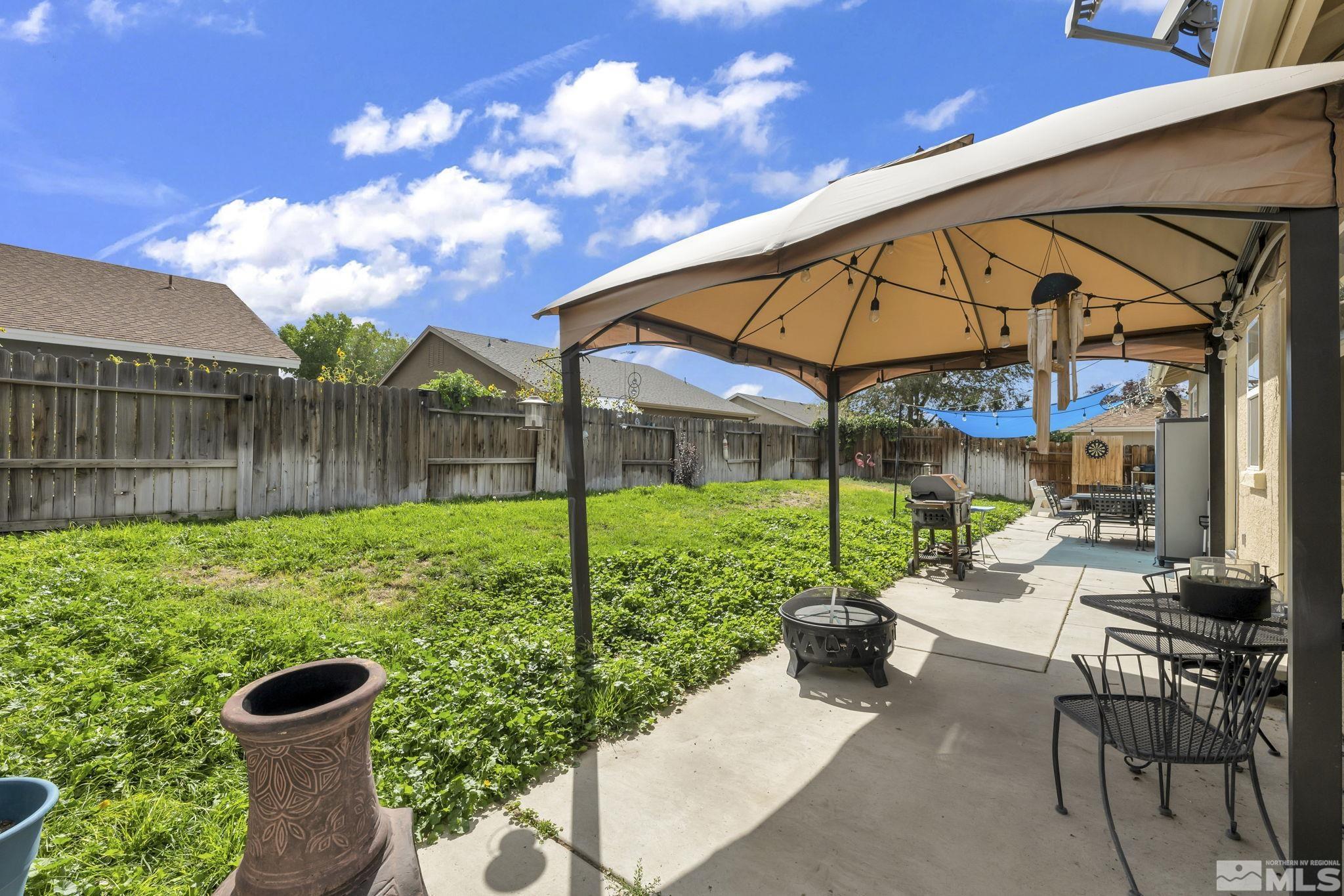 407 Sunshine Lane Fernley, NV 89408 - Photo 25 of 26 a view of a chair and tables in the backyard