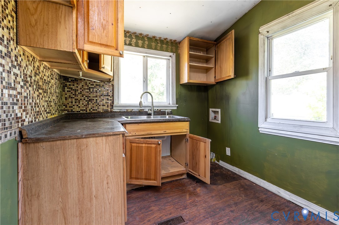 13512 Queen Street Disputanta, VA 23842 - Photo 14 of 46 a kitchen with stainless steel appliances granite countertop a sink a stove and a wooden cabinets