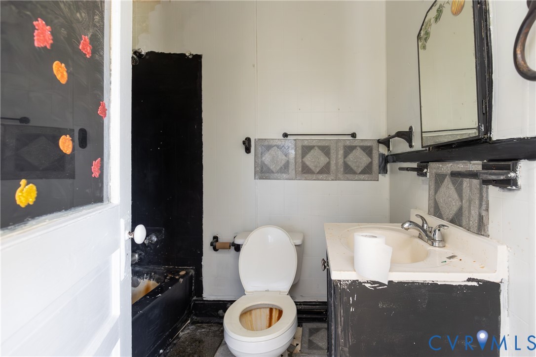 13512 Queen Street Disputanta, VA 23842 - Photo 26 of 46 a bathroom with a granite countertop sink and a mirror