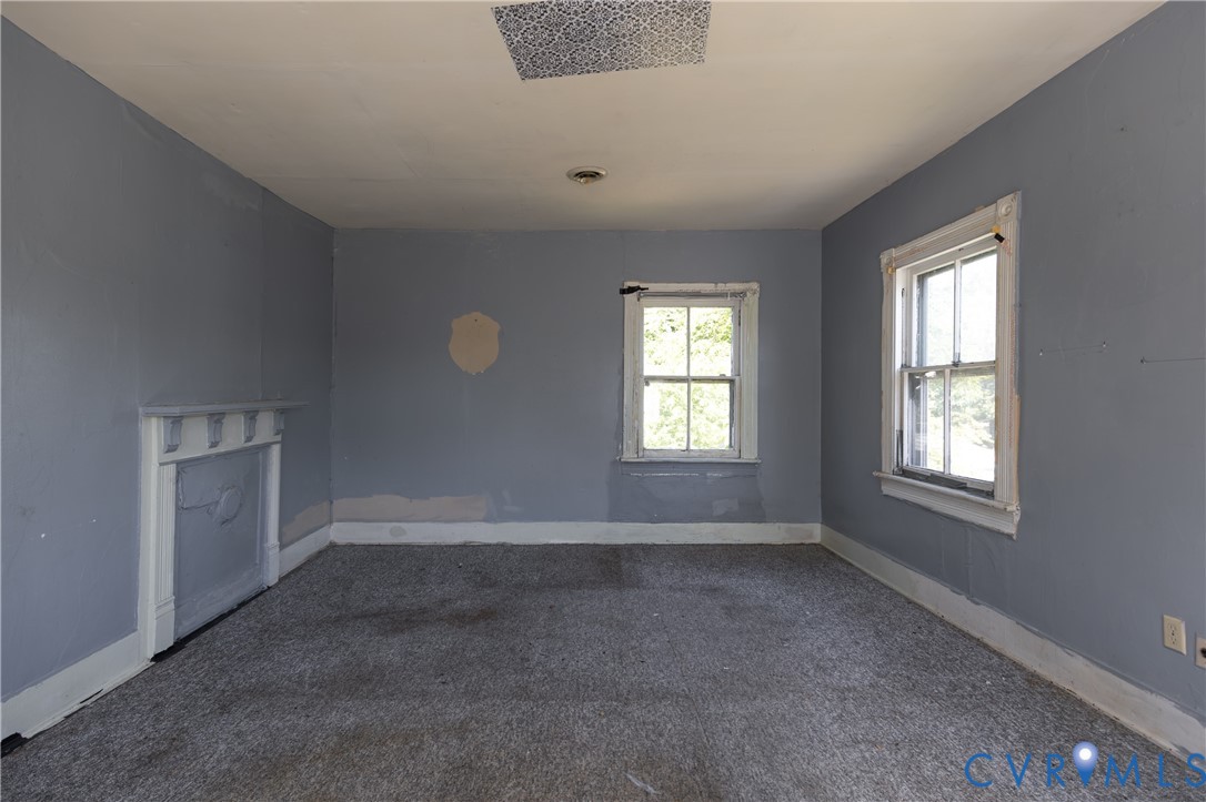 13512 Queen Street Disputanta, VA 23842 - Photo 28 of 46 an empty room with windows