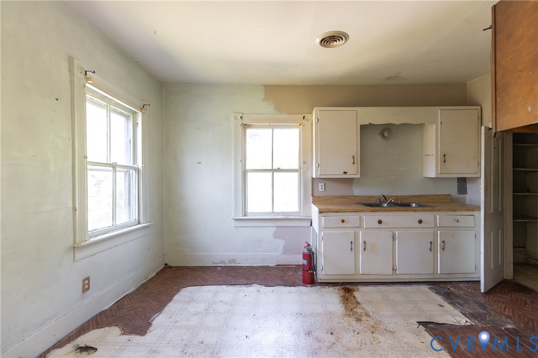 13512 Queen Street Disputanta, VA 23842 - Photo 34 of 46 a spacious bathroom with a granite countertop sink and a window