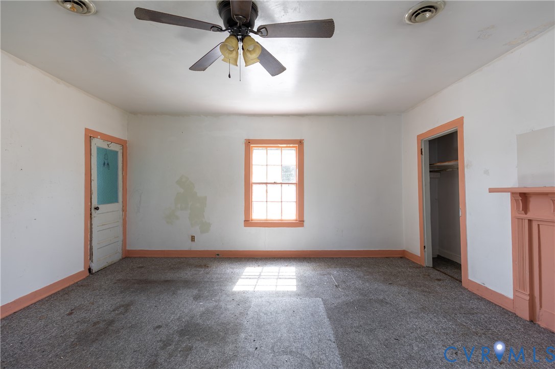 13512 Queen Street Disputanta, VA 23842 - Photo 37 of 46 en empty room with windows and fan