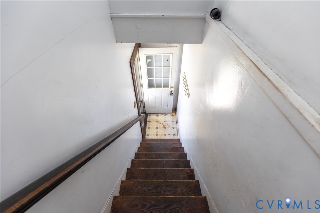 13512 Queen Street Disputanta, VA 23842 - Photo 40 of 46 a view of a hallway with wooden floor and a chandelier