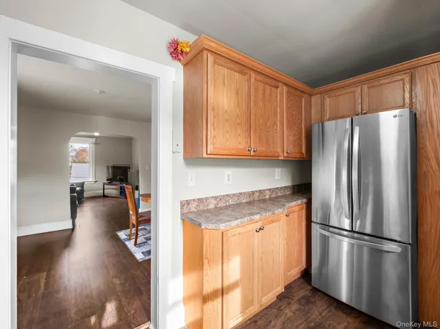 a view of a workspace with wooden floor and a window