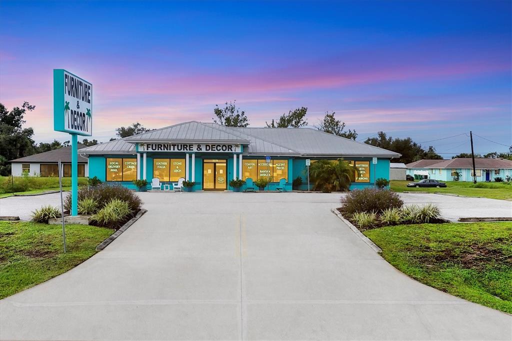 3285 South Access Road Englewood, FL 34224 - Photo 4 of 20 a front view of a house with a yard