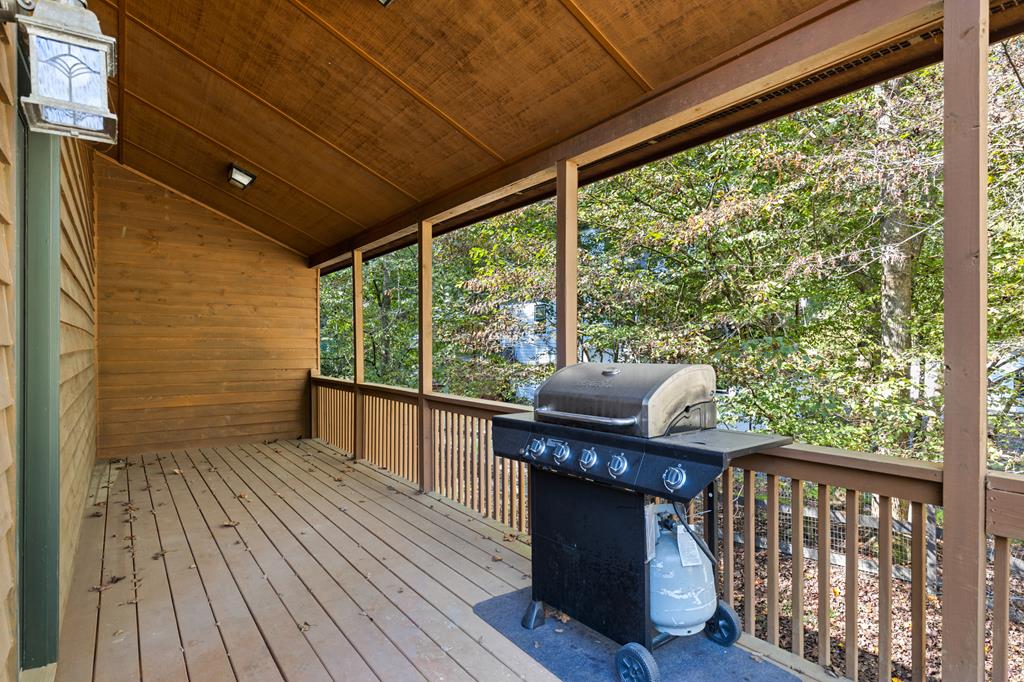 96 Holiday Court Ellijay, GA 30540 - Photo 39 of 51 a balcony with wooden floor table and chairs