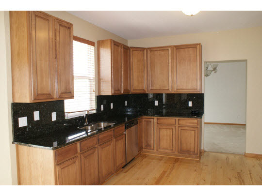 1446 Rock Island Road Davis Junction, IL 61020 - Photo 3 of 11 a kitchen with granite countertop a sink a stove and cabinets