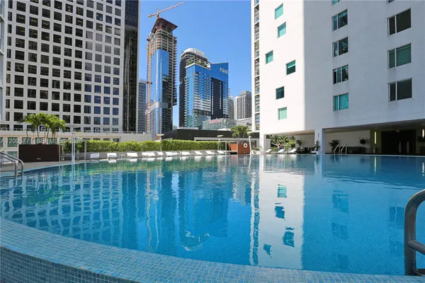 a swimming pool with outdoor seating and yard