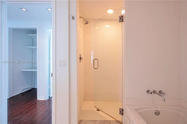 a bathroom with a bathtub and a shower
