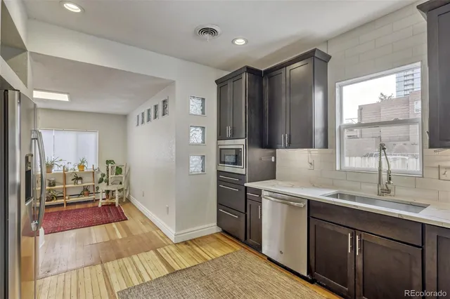 a kitchen with a sink stove and refrigerator