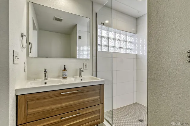 a bathroom with a sink a vanity and a mirror