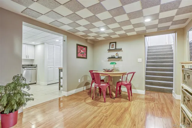 a dining room with furniture and wooden floor