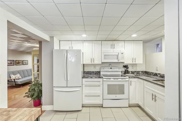 a white refrigerator freezer sitting inside of a kitchen