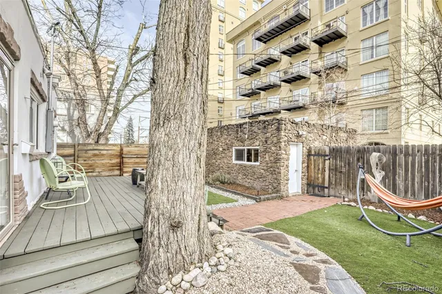 a view of a chair and tables in the patio with a yard