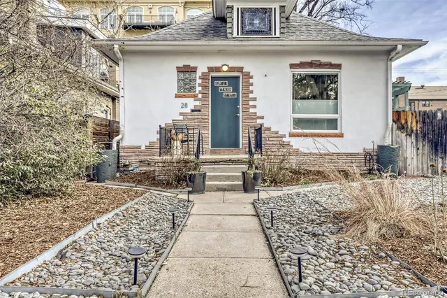 a view of a pathway with a house on the background