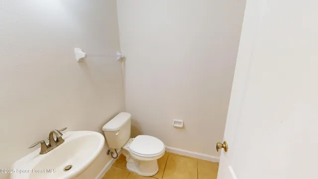 a white toilet sitting next to a bathroom sink