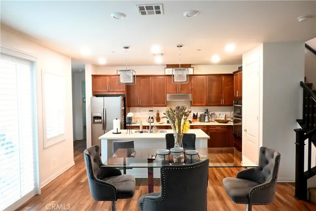 a living room with lots of furniture and kitchen view