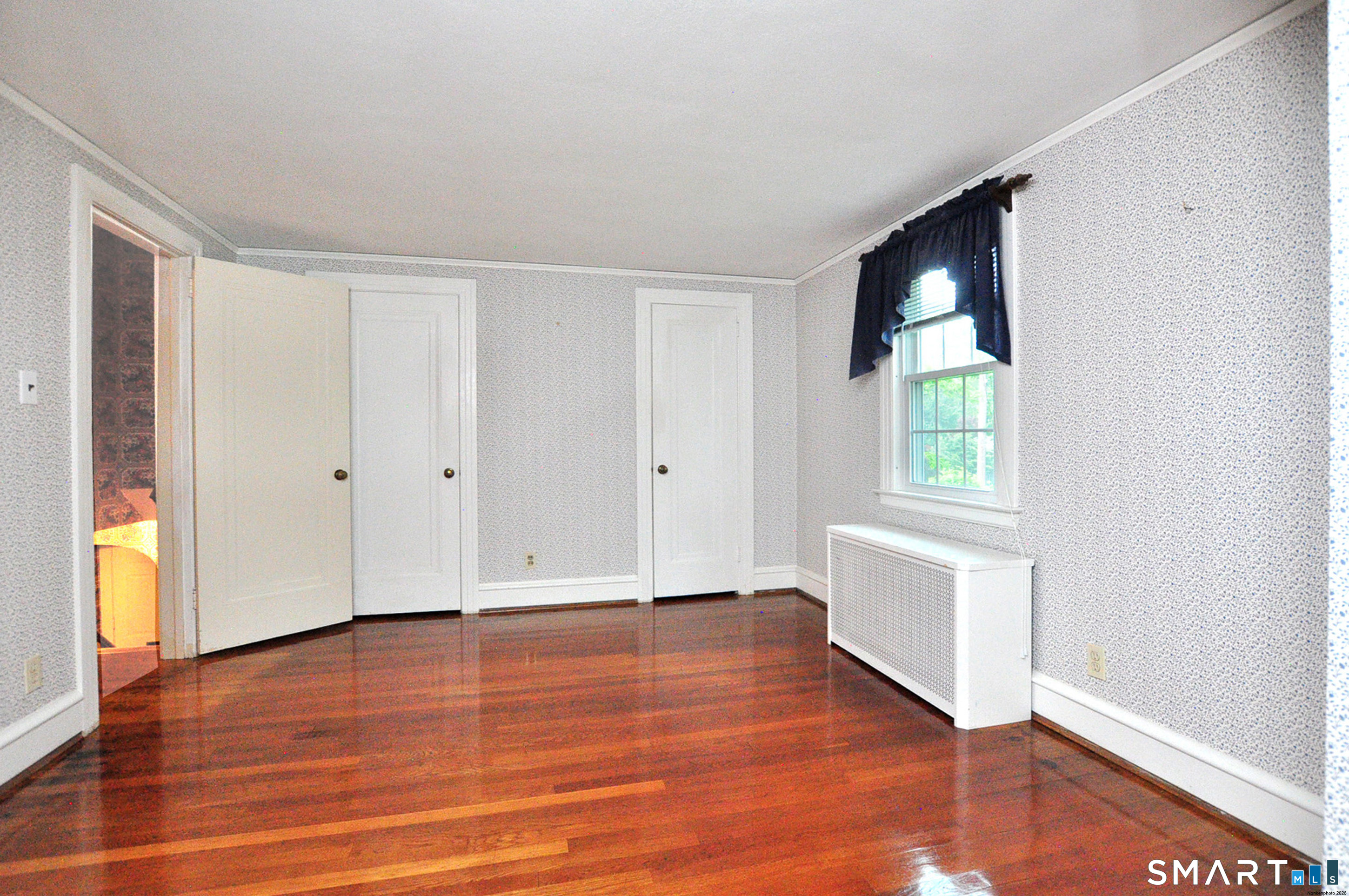 10 Harvey Road Windsor, CT 06095 - Photo 18 of 36 an empty room with wooden floor and windows