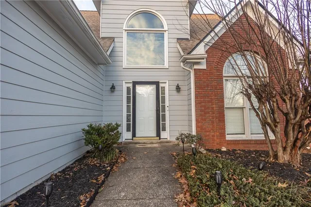 a front view of a house with garden