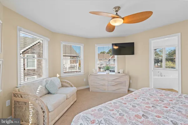 a bedroom with a bed chandelier and a window