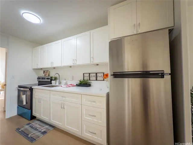 a kitchen with a refrigerator and cabinets