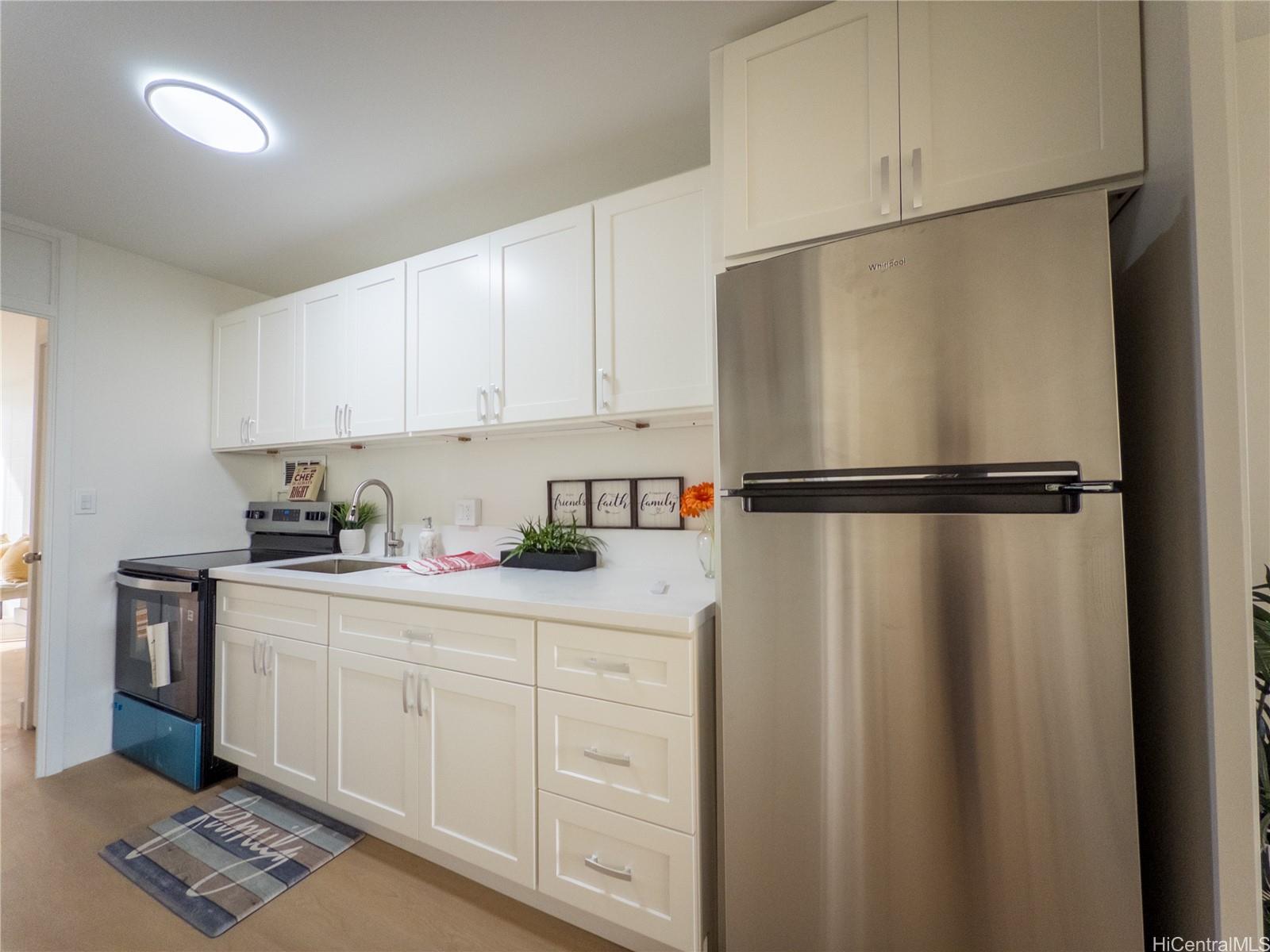 a kitchen with a refrigerator and cabinets