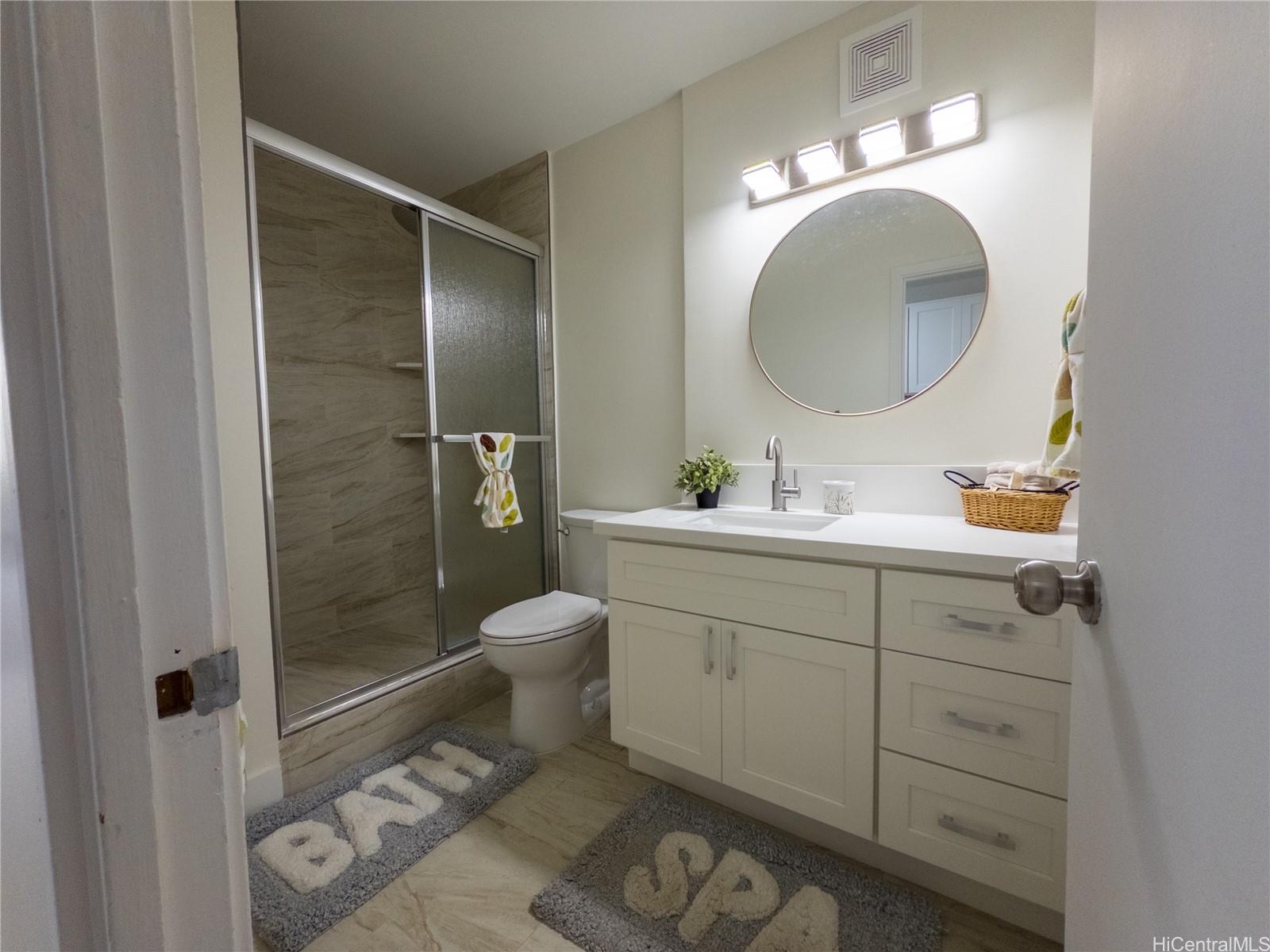 425 Ena Road, Unit 607C Honolulu, HI 96815 - Photo 11 of 21 a bathroom with a toilet a sink and mirror