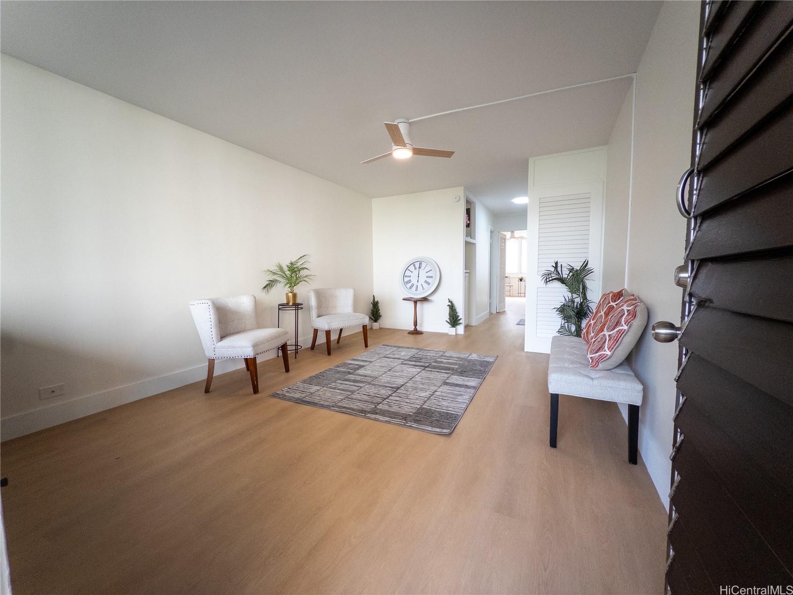 425 Ena Road, Unit 607C Honolulu, HI 96815 - Photo 7 of 21 a living room with furniture and wooden floor