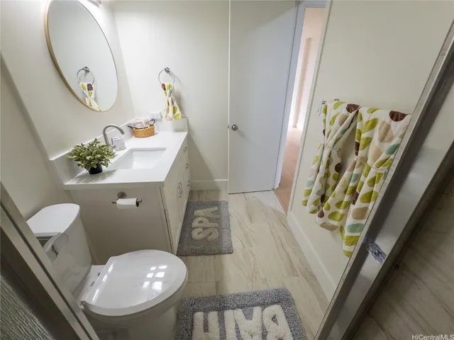 a bathroom with a toilet a sink and mirror