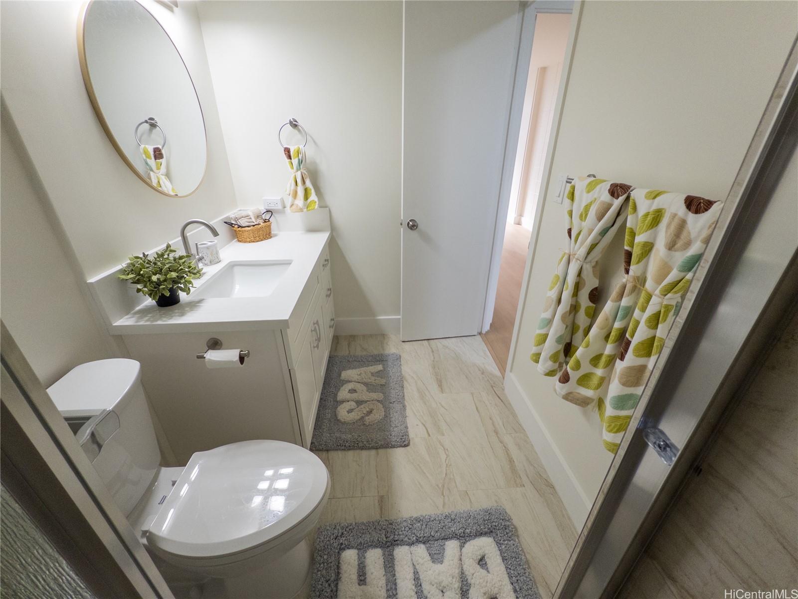 425 Ena Road, Unit 607C Honolulu, HI 96815 - Photo 9 of 21 a bathroom with a toilet sink and mirror