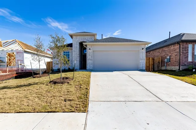 a view of a house with snow on the road