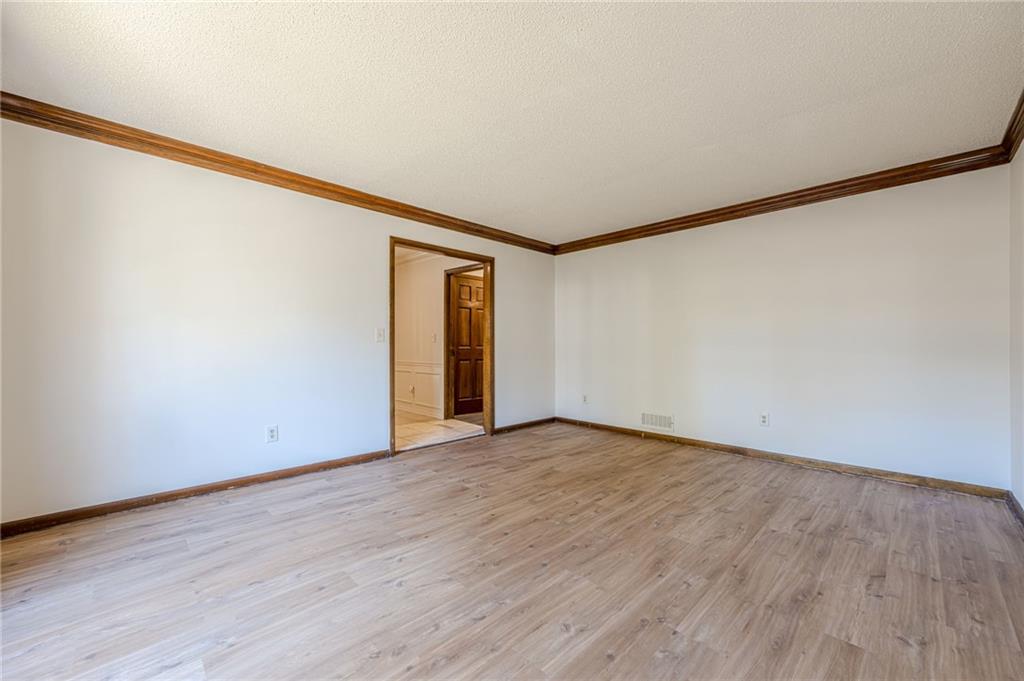 4147 Scofield Place Stone Mountain, GA 30083 - Photo 11 of 56 a view of an empty room with wooden floor