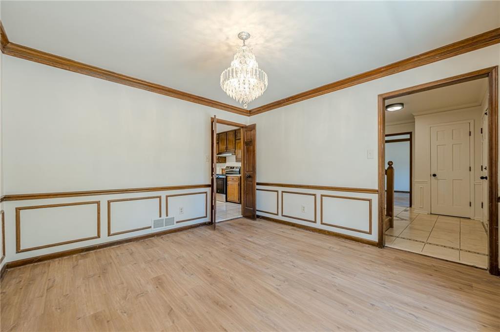 4147 Scofield Place Stone Mountain, GA 30083 - Photo 13 of 56 a view of an empty room with wooden floor