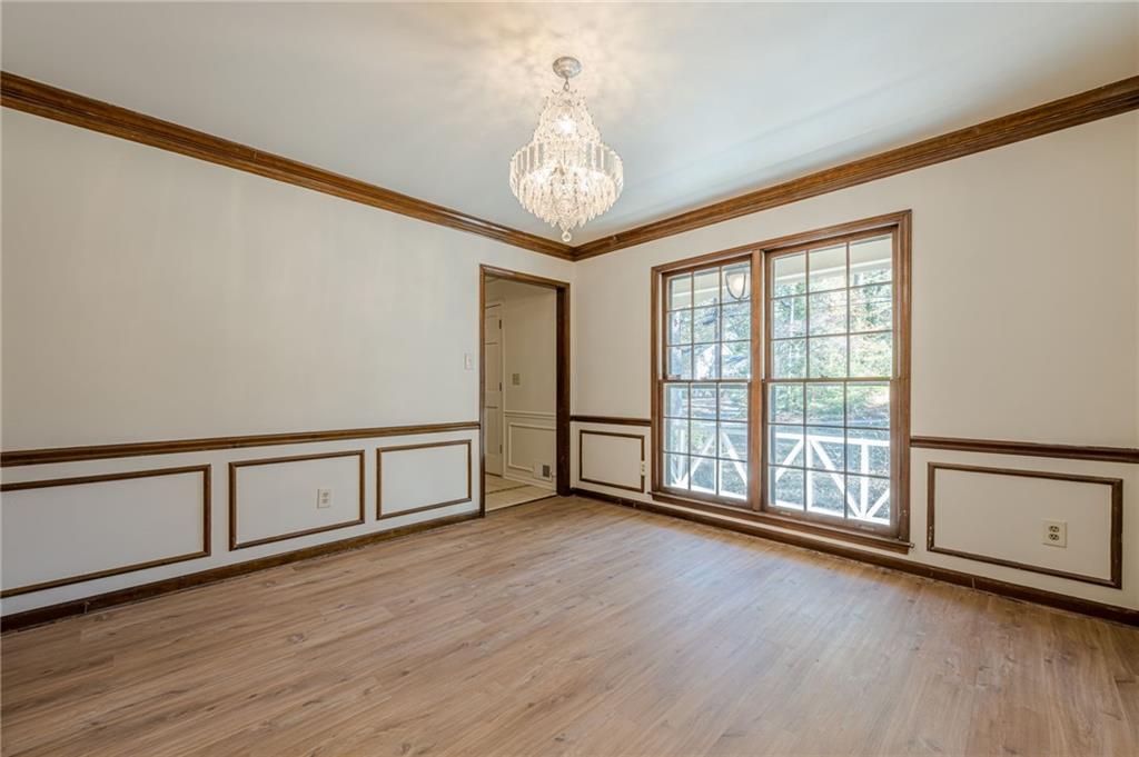 4147 Scofield Place Stone Mountain, GA 30083 - Photo 14 of 56 a view of an empty room with wooden floor