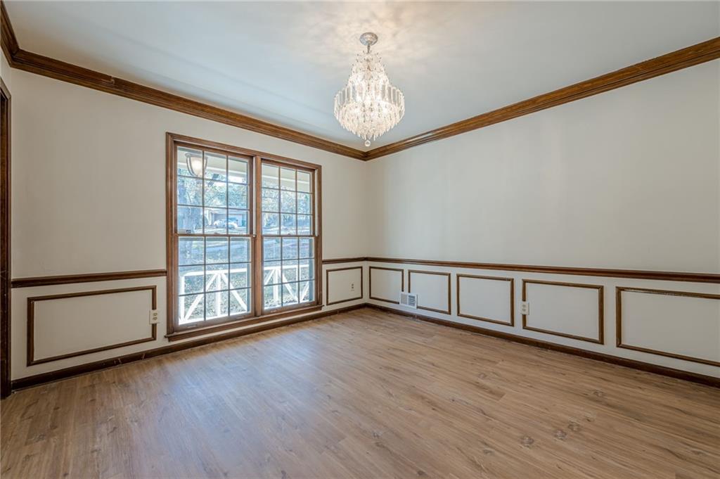 4147 Scofield Place Stone Mountain, GA 30083 - Photo 15 of 56 a view of an empty room with wooden floor