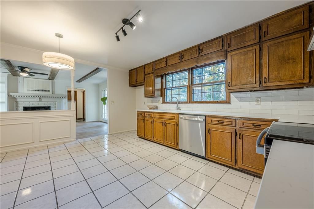 4147 Scofield Place Stone Mountain, GA 30083 - Photo 16 of 56 a kitchen with stainless steel appliances granite countertop a stove a sink and a refrigerator