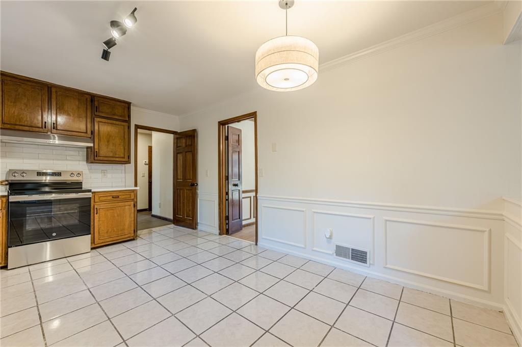 4147 Scofield Place Stone Mountain, GA 30083 - Photo 20 of 56 a kitchen with granite countertop a refrigerator and a stove top oven