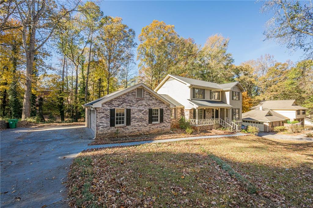 4147 Scofield Place Stone Mountain, GA 30083 - Photo 2 of 56 a front view of a house with a yard