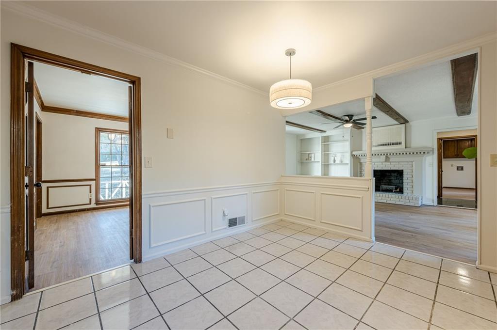 4147 Scofield Place Stone Mountain, GA 30083 - Photo 22 of 56 an empty room with fireplace and wooden floor