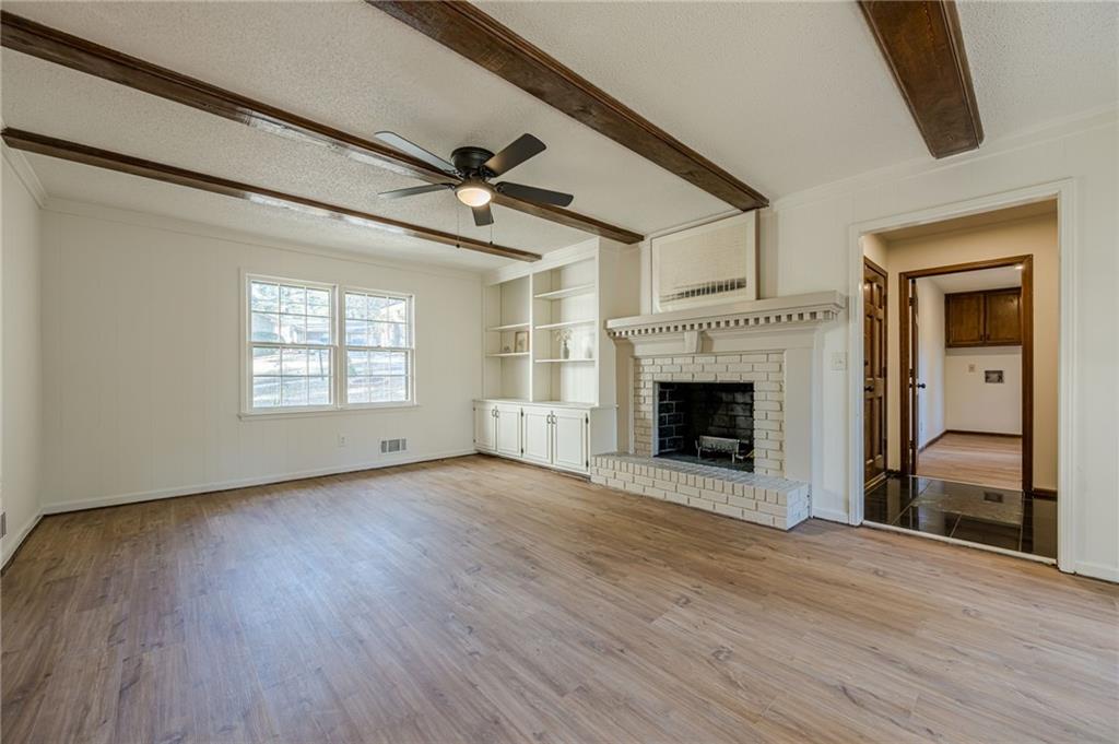 4147 Scofield Place Stone Mountain, GA 30083 - Photo 23 of 56 a view of an empty room with a fireplace and a window