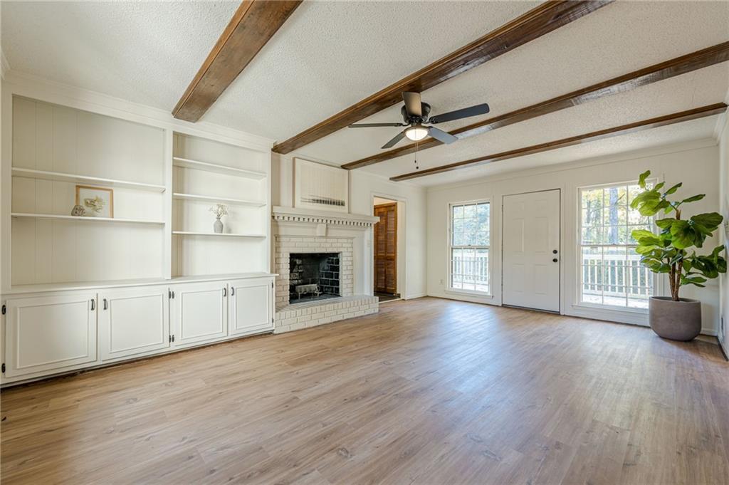 4147 Scofield Place Stone Mountain, GA 30083 - Photo 25 of 56 a view of empty room with wooden floor and fireplace