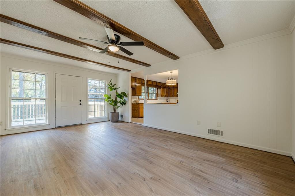 4147 Scofield Place Stone Mountain, GA 30083 - Photo 26 of 56 a view of an empty room with a window and wooden floor