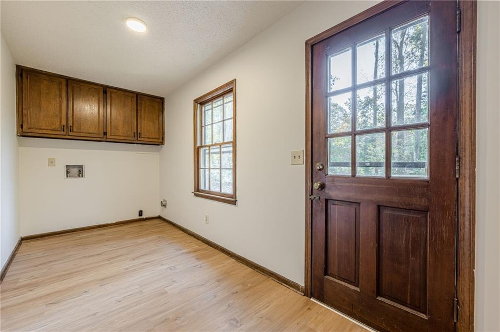4147 Scofield Place Stone Mountain, GA 30083 - Photo 28 of 56 a view of an empty room with wooden floor and a window