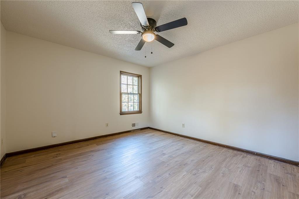 4147 Scofield Place Stone Mountain, GA 30083 - Photo 30 of 56 an empty room with wooden floor and windows