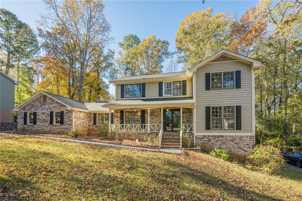 4147 Scofield Place Stone Mountain, GA 30083 - Photo 3 of 56 a front view of a house with a yard and garage