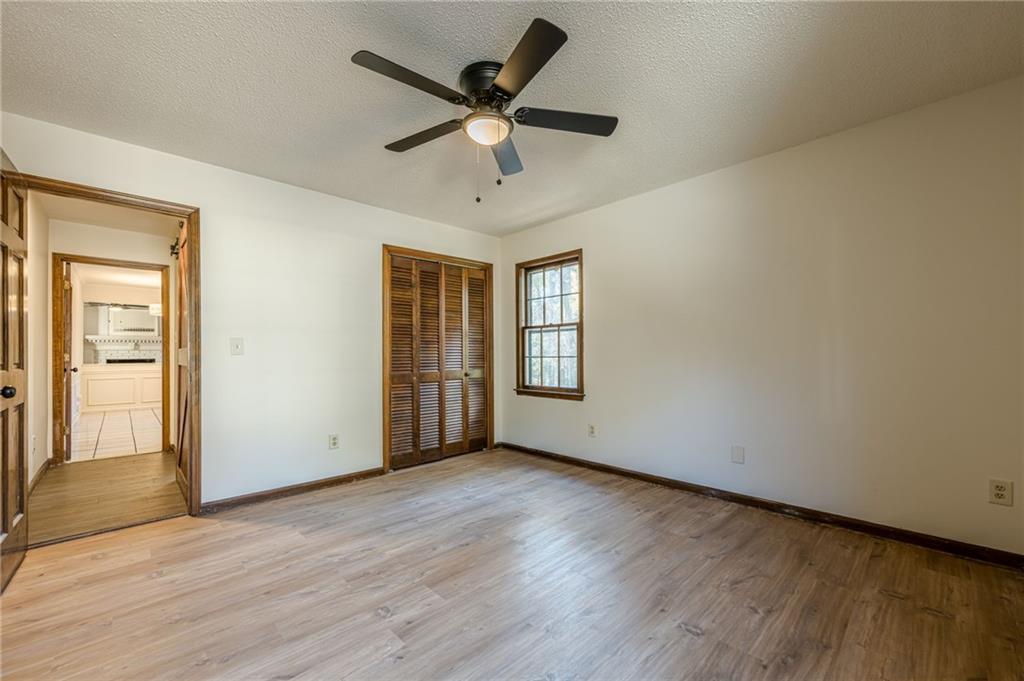 4147 Scofield Place Stone Mountain, GA 30083 - Photo 31 of 56 a view of an empty room with window and wooden floor